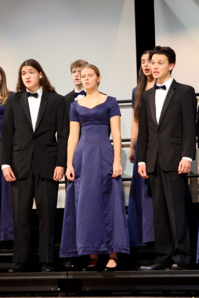 Juniors Keegan Wootton and Sienna Suderman sing along with senior Zane Lauer to renditions of popular Christmas songs.