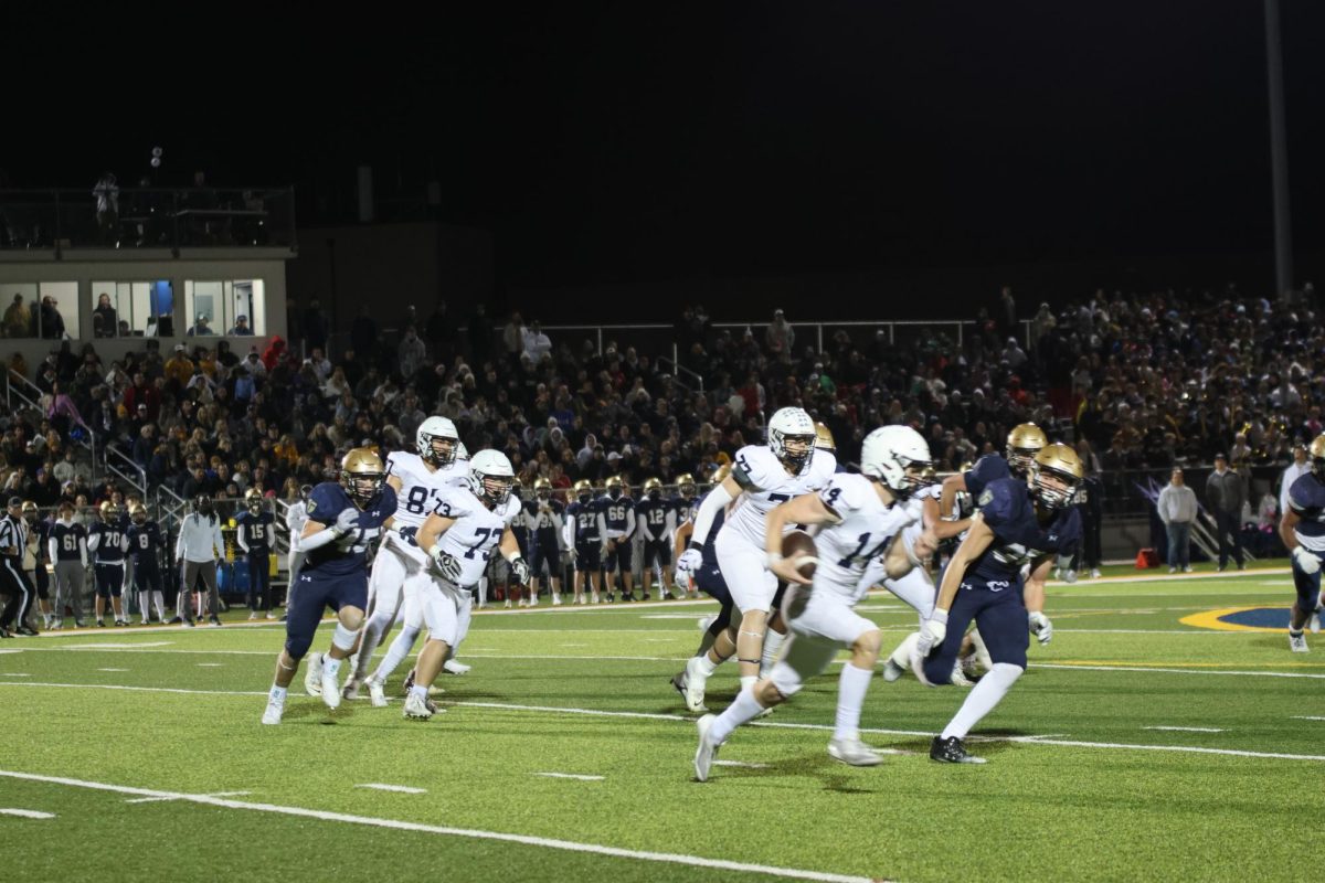 Senior Connor Bohon rushes the ball down the field to complete a touchdown.