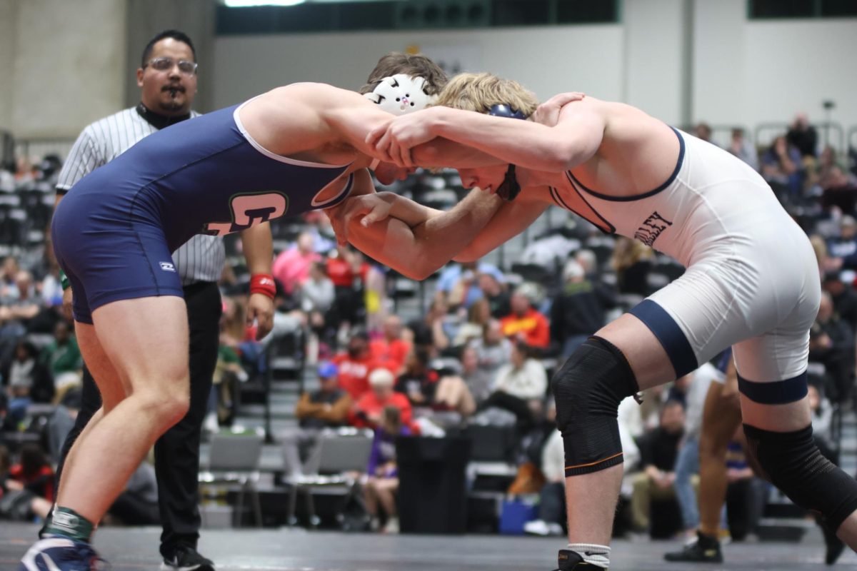 Holding arms, senior Colton Bendure holds his opponent in place.