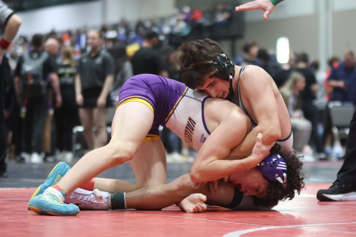 Sitting down, sophomore Ethan Leon holds down his opponent.