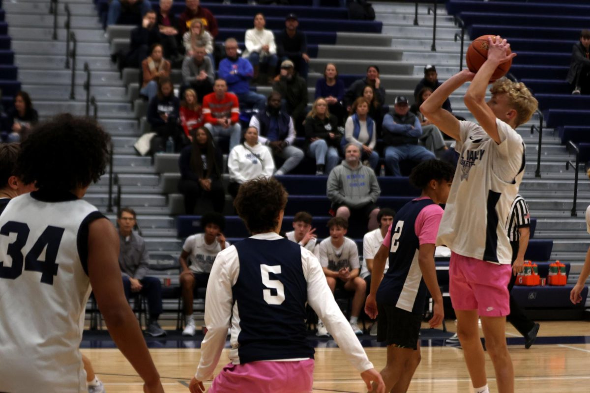 Sophomore Kai Campbell takes a jumshot over junior Reece Riedel. 