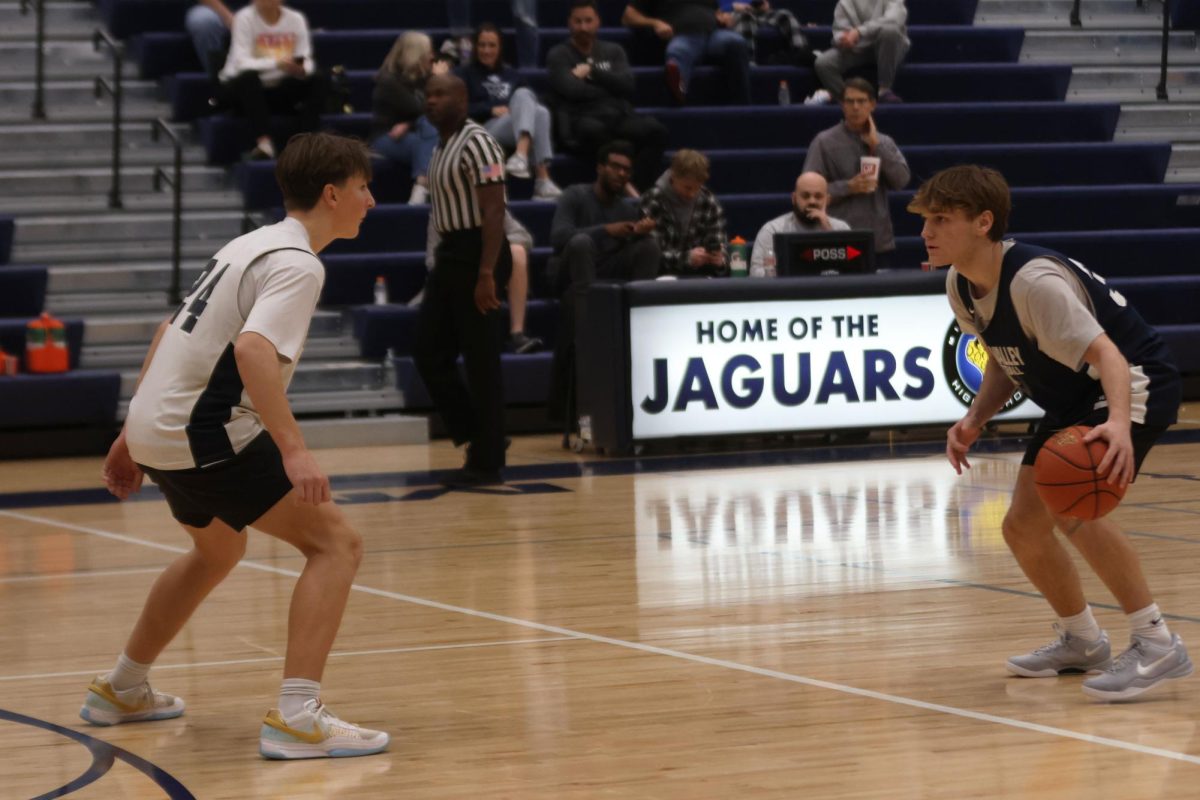 Sophomore Charles Bullard goes head to head as junior Grant Kuchynka tries to steal the ball on Friday, December 6th. 