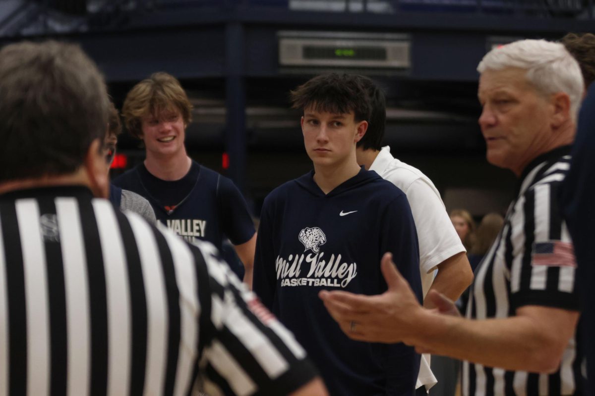 At the end of the basketball scrimmage, junior Jack Carpenter listens attentively to the referees' and coaches' final words on Friday, December 6th. 