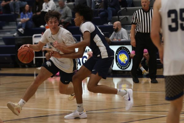 Sophomore AJ Davis tries to steal the ball as Sophomore Grady Lanson dribbles around him at the December 6th basketball scrimmage. 
