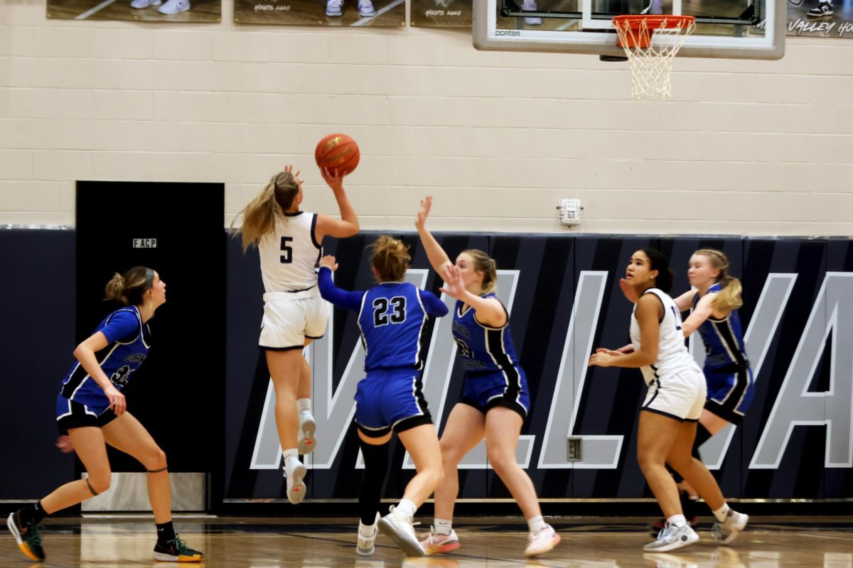 Senior Josie Benson attempts to make a shot during the first quarter.