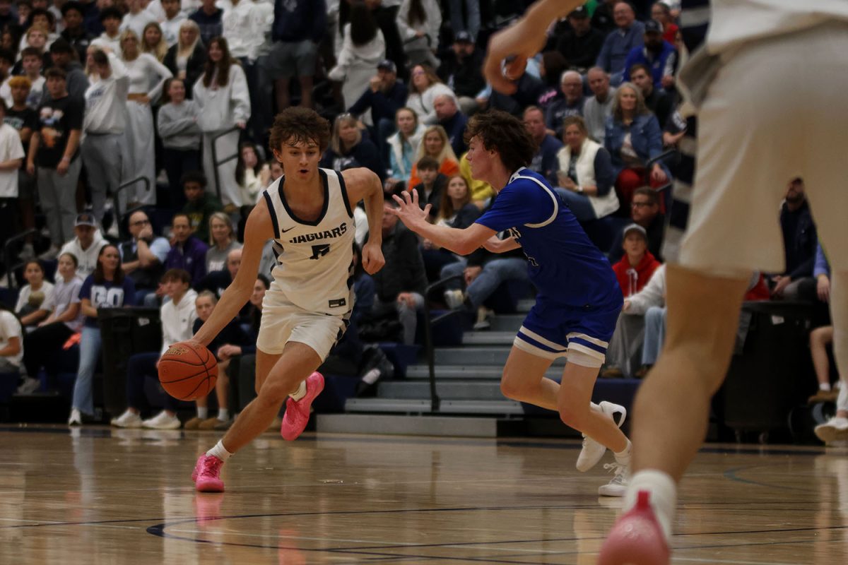 Focused, junior Reece Riedel gets around a Gardner Edgerton player. 