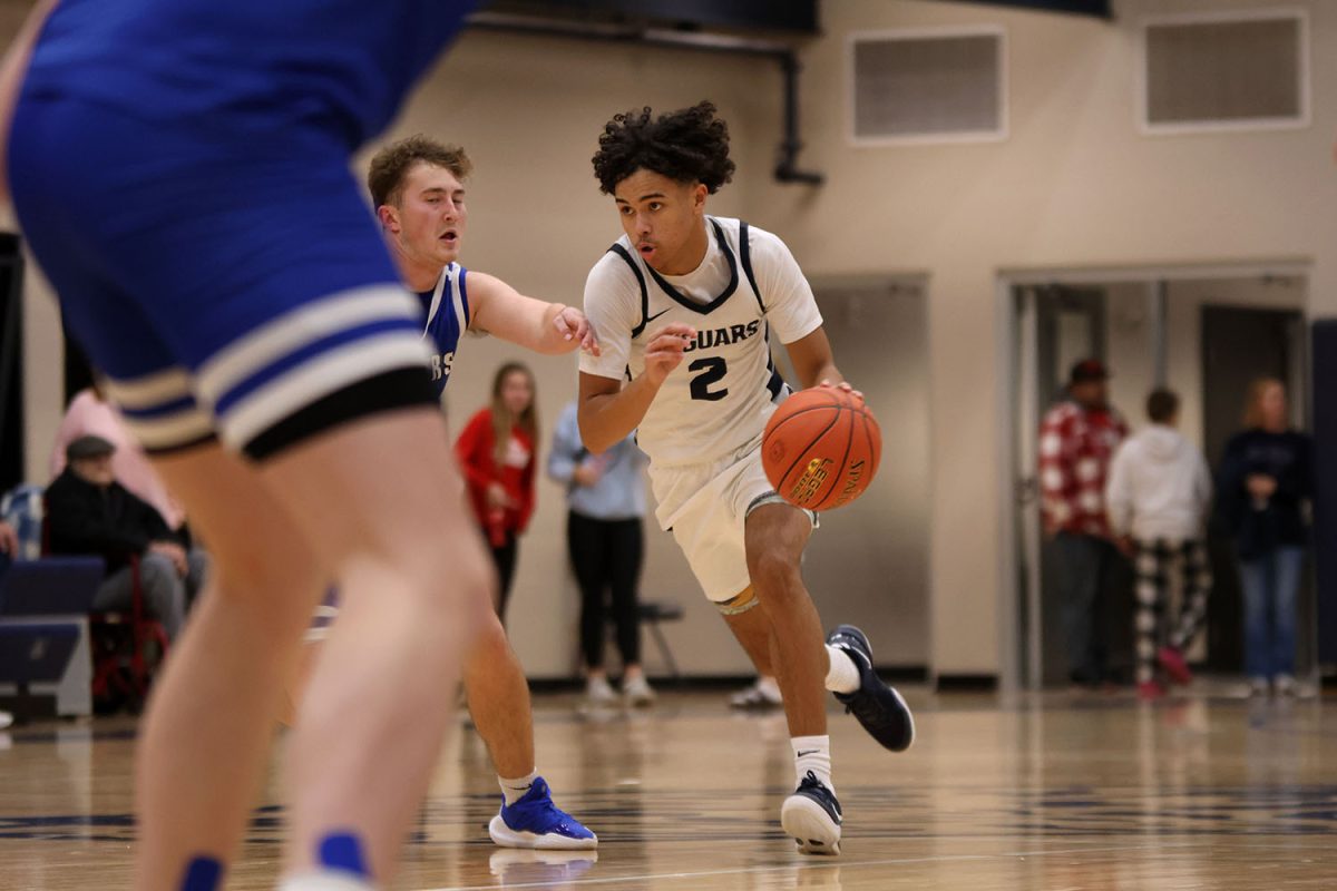 Junior JaKhai Carter makes his way through the middle of the court.