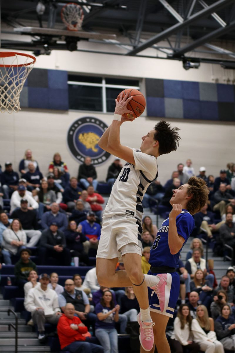 Taking a shot, junior Jack Carpenter makes a basket. 