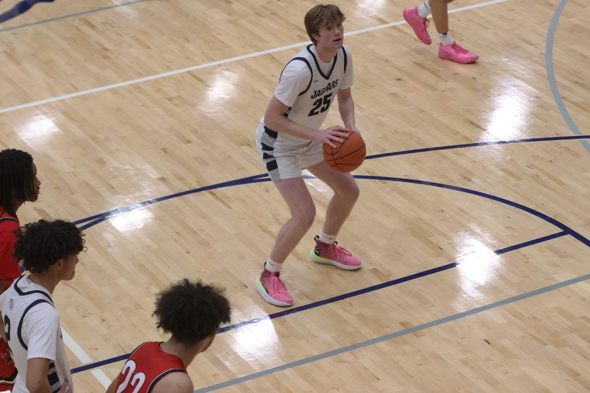 Focusing on the shot, senior Carter Kaifes prepares to shoot the ball, Tuesday Jan. 14.