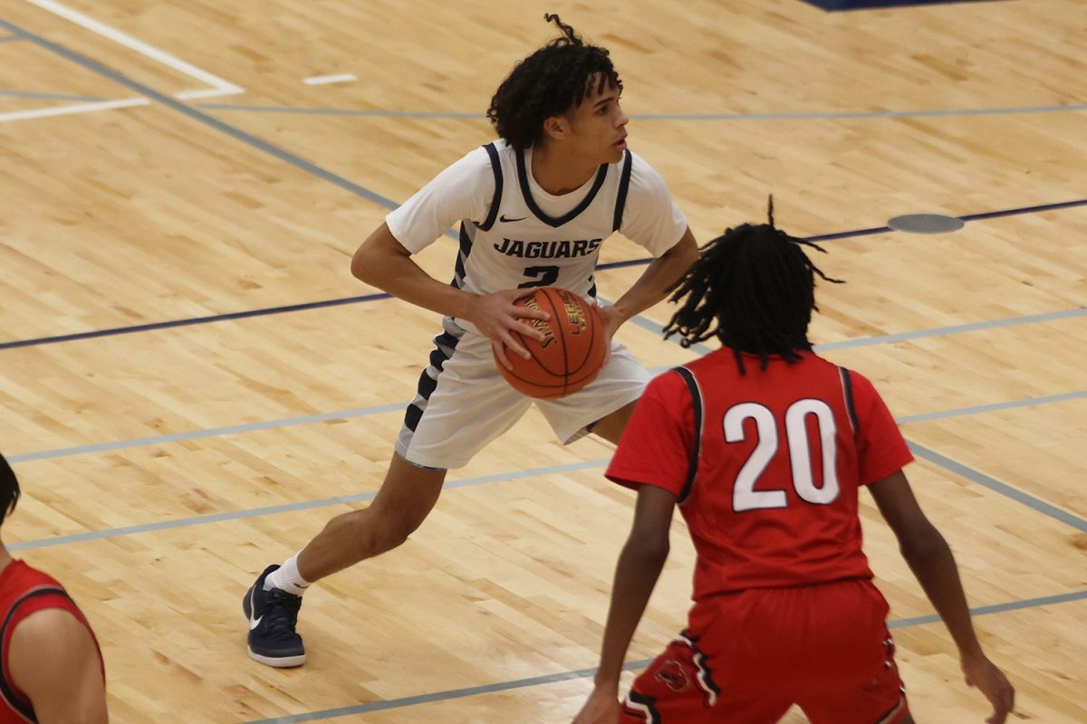 Looking for a teammate, junior JaKhai Carter tries to pass the ball off. 