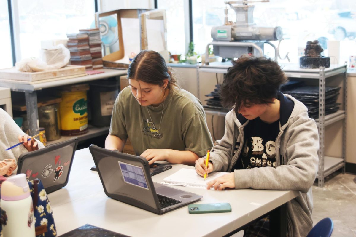 Juniors Cat Rivas and Nick Baird sketch out their ideas before beginning with clay. 