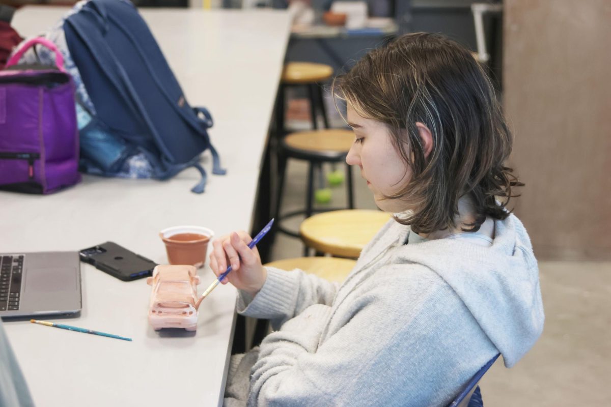 Junior Kaitlyn Shinkle focuses as she paints her work. 