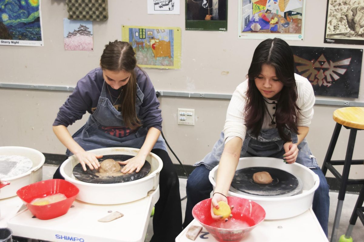 Sophomores Molly Gilmore and Emerson Tran start new projects on the wheel. 