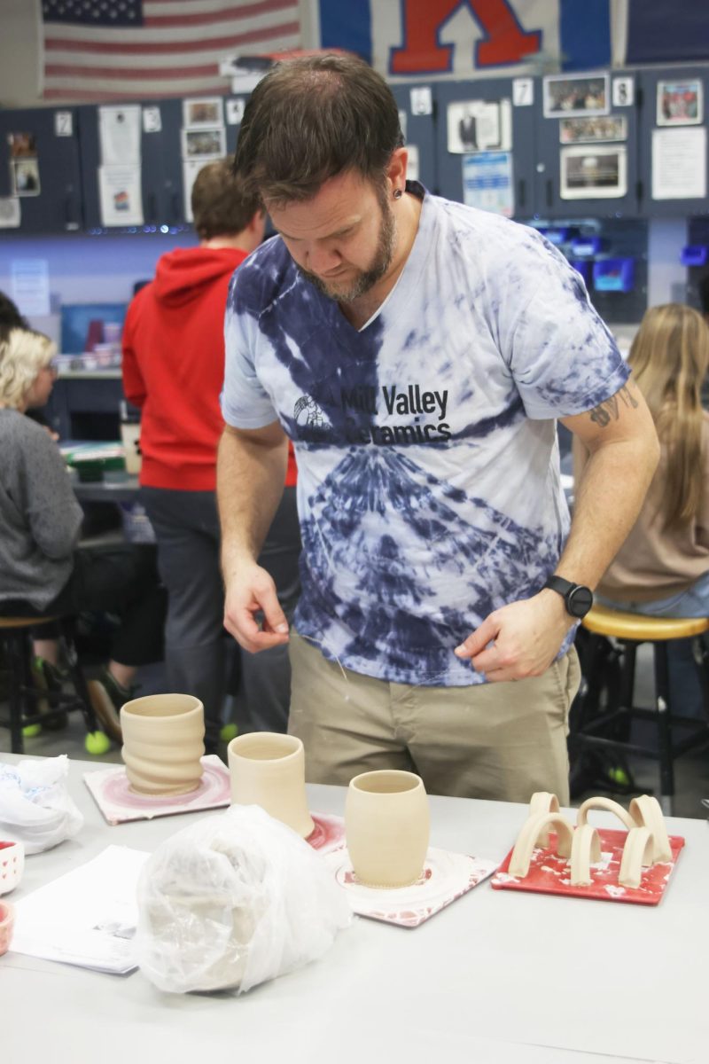 Ceramics teacher and club sponsor Bryan Lloyd works with on his personal project. 