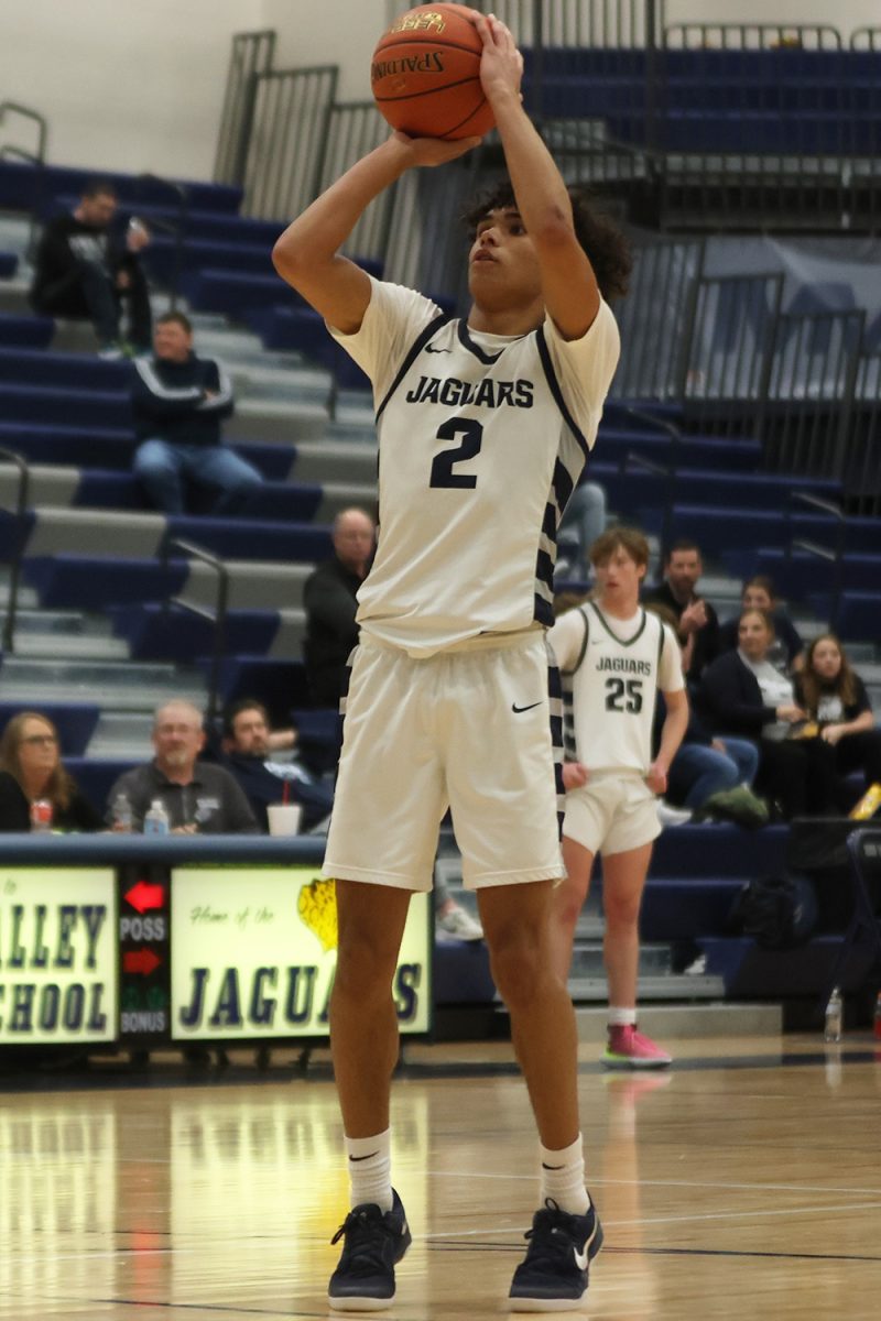 Shooting for the point, junior JaKhai Carter focuses on the basket. 