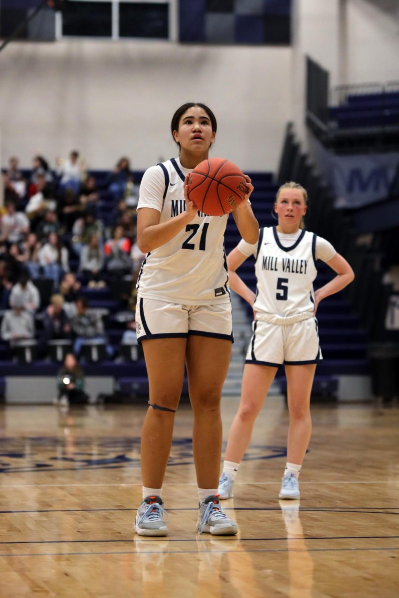 Focusing on the basket, sophomore Alexa Short prepares to shoot a free throw.