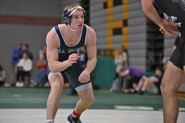 Watching the other wrestler, junior Cru Akin stays on his feet.