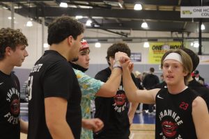 Seniors Abe Shaffer, Clayton Sondergoth go into the team huddle to start the game.