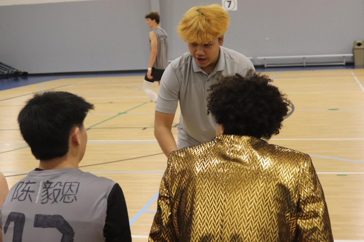 Senior Jaikub Srivisay takes his player senior Ian Chern through the game plan.