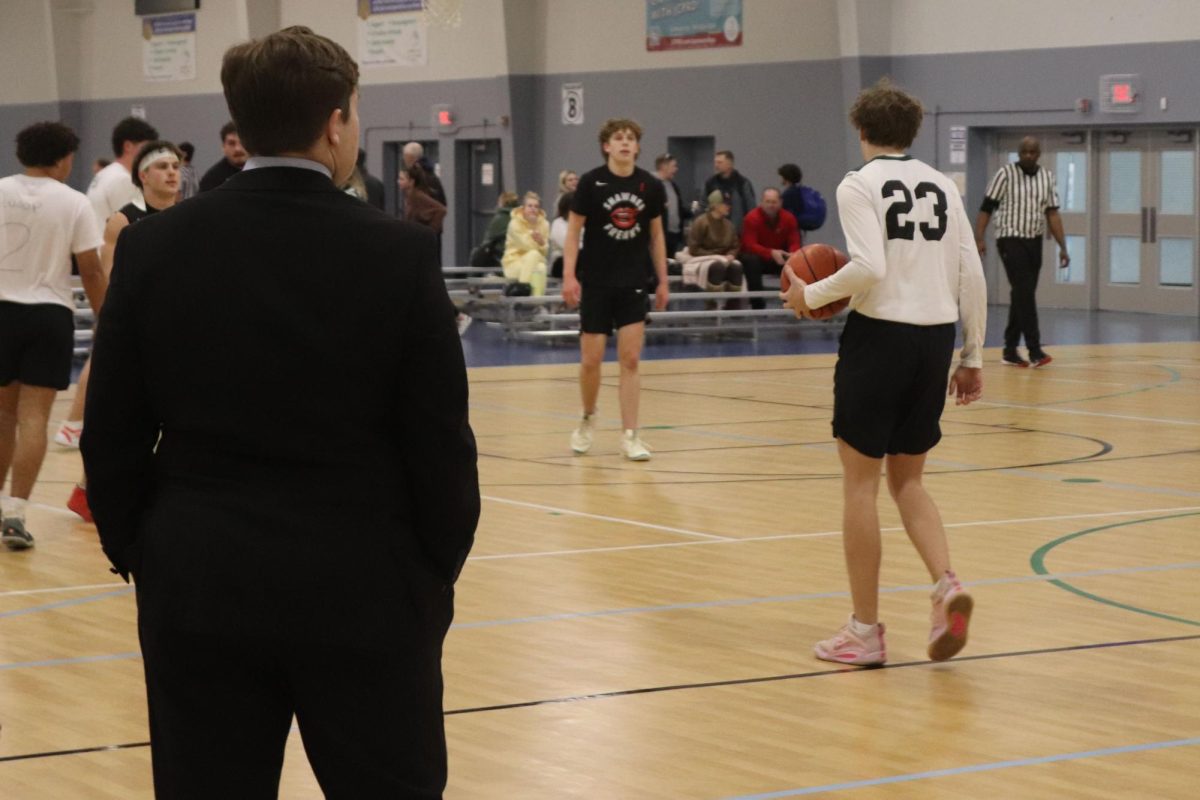 Senior Hank Danielson watches senior  Grayson Moore take the ball up the court. 