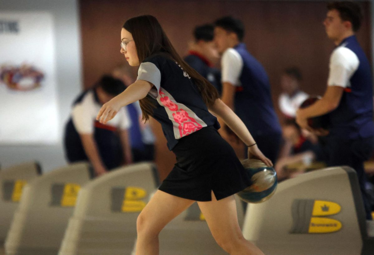 Walking up to the lane, sophomore Ella Diehl prepares to roll the ball. 