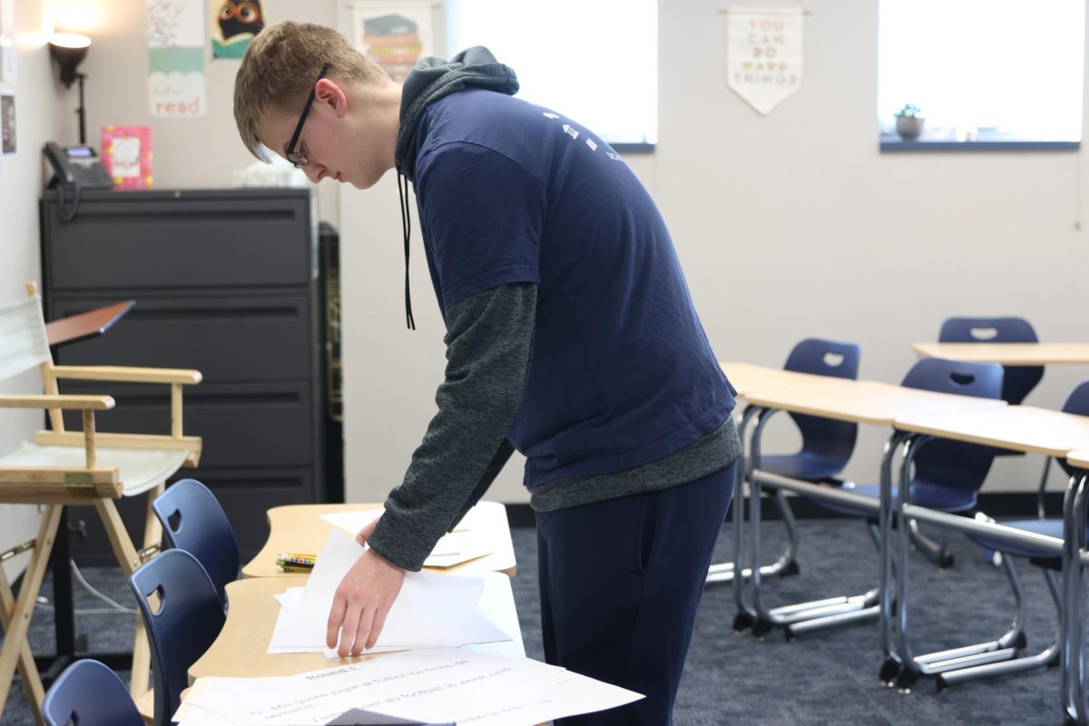 Junior Sam Bowling lays out scratch paper for competitors.