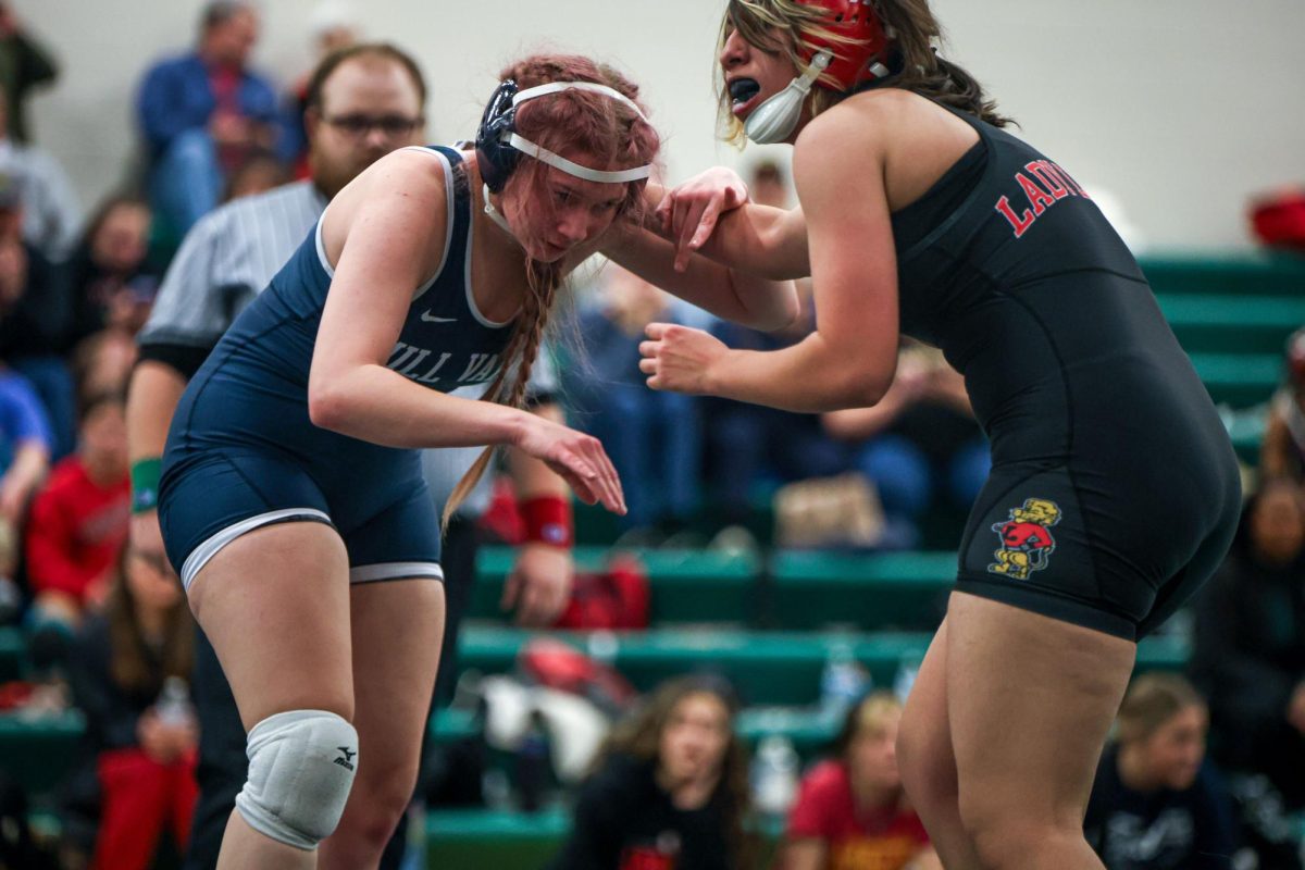 Making eye contact with her opponent, junior Jocelyn Paulsen looks for an opportunity to pin her opponent. 