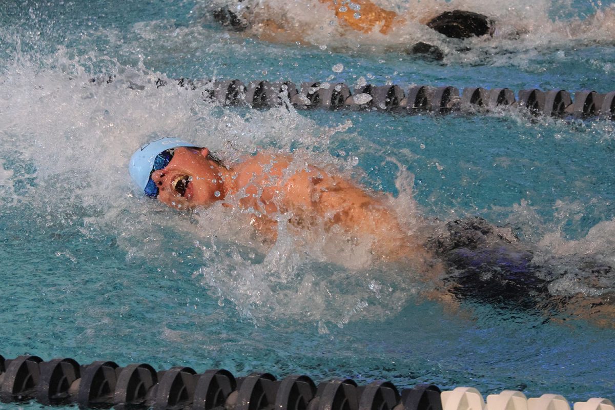 Before finishing his race, senior Sawyer Clark takes a breath in the 50 yard freestyle.
