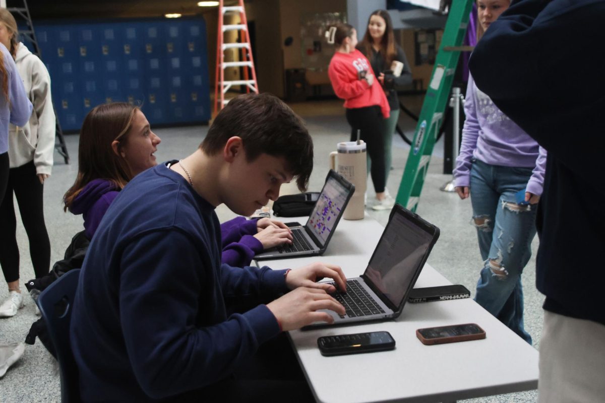 Seniors Meg McAfee and Matt Tieman check each Relay for Life member in and explain what their role will be in the setup of Purple Bomb on January 20. 