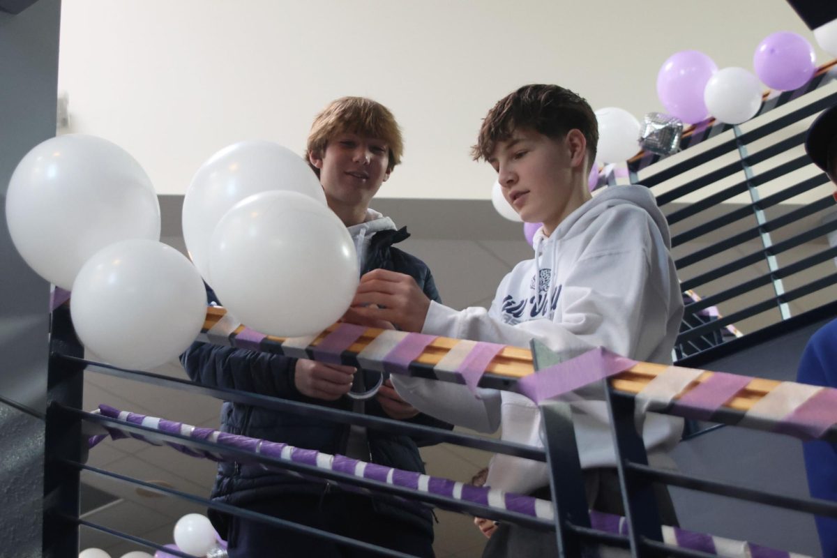 Seniors Meg McAfee and Matt Tieman check each Relay for Life member in and explain what their role will be in the setup of Purple Bomb on January 20. 