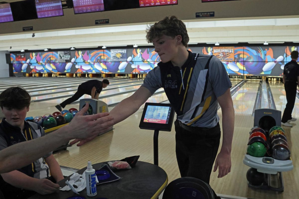 After closing the frame, sophomore Devin Leiker receives a high five from his teammate.