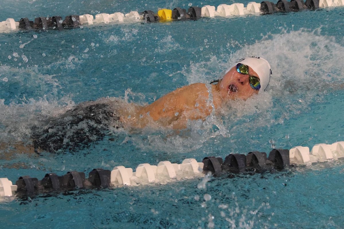 Building momentum, freshman Nathan Reedy begins his swim in the 50 yard freestyle.
