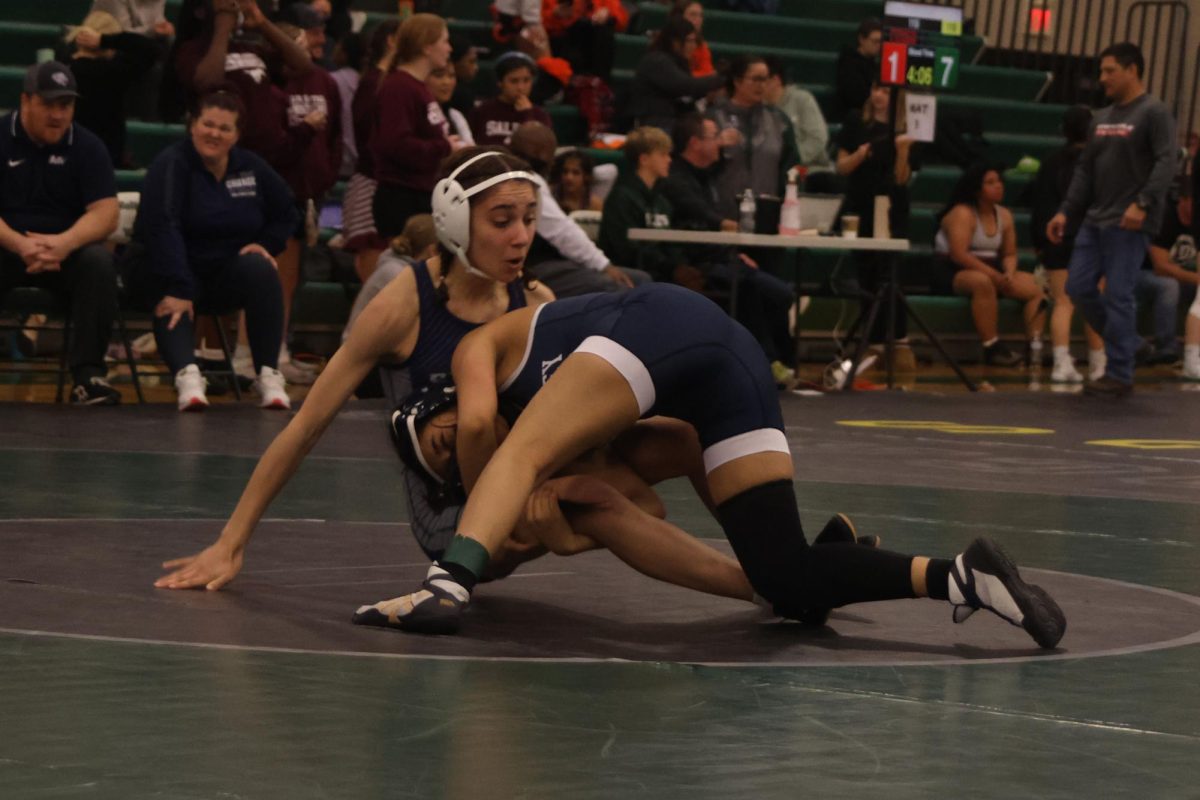 Reaching for the legs, sophomore Emma Mayorga tackles her opponent, resulting in a point.
