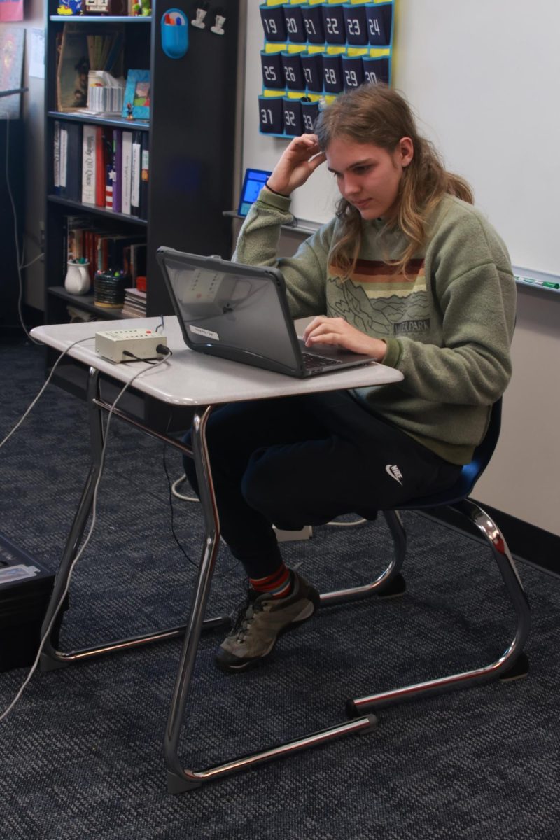 Junior William Schieber rattles off questions to his fellow Scholars Bowl members.
