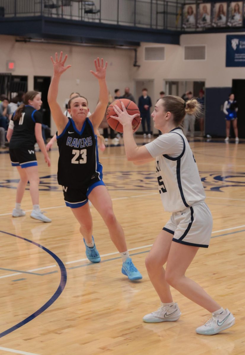 Hands on the ball, sophomore Riley Marshall prepares to pass to a teammate.
