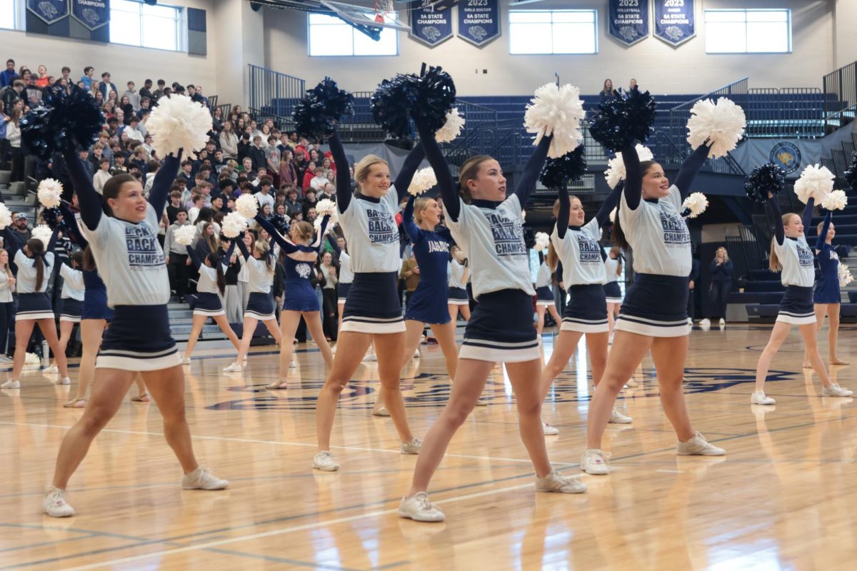 The girls on the Mill Valley cheer squad welcome people in to the gym with amazing school spirit.