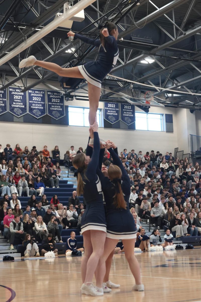 Getting held up by her friends, senior Jada Winfrey poses confidently in the air.