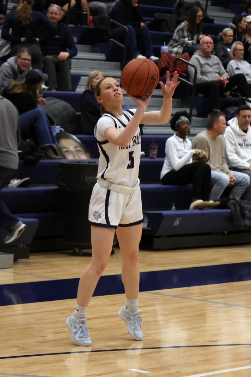 Focused on the basket, senior Josie Benson shoots an open three-pointer