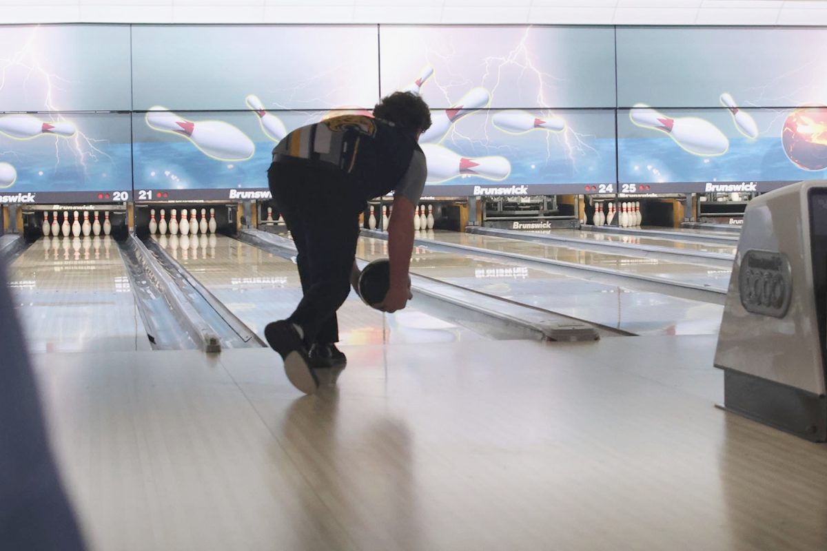 Low to the ground, sophomore Ian Field finds the perfect spot for the ball to hit the pins, Tuesday, Feb. 4.