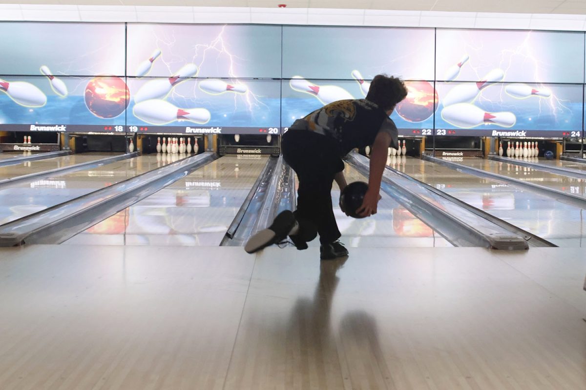 Bowling with two hands, sophomore Devin Leiker focuses on what  angle to throw the ball, Tuesday, Feb. 4.