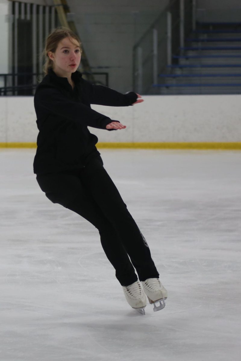 Lifting one foot off the ice, freshman Delaney Konen skates across the ice during her practice Wednesday Feb. 5. 