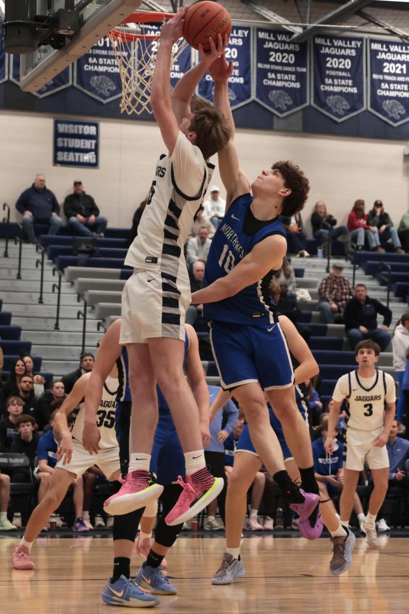 Senior Carter Kaifes battles against his defender while shooting the ball.