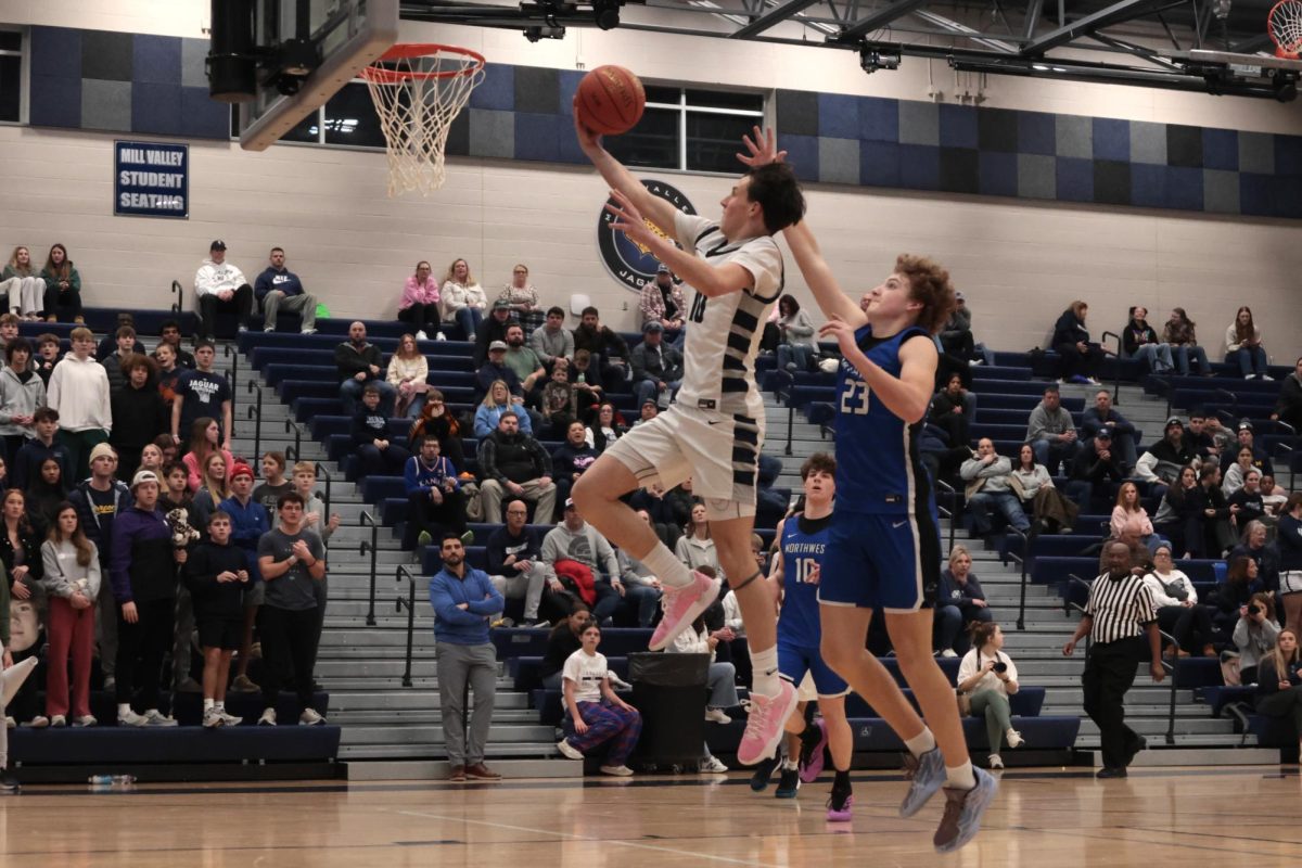 Ahead of Olathe Northwest, junior Jack Carpenter takes a leap to score.