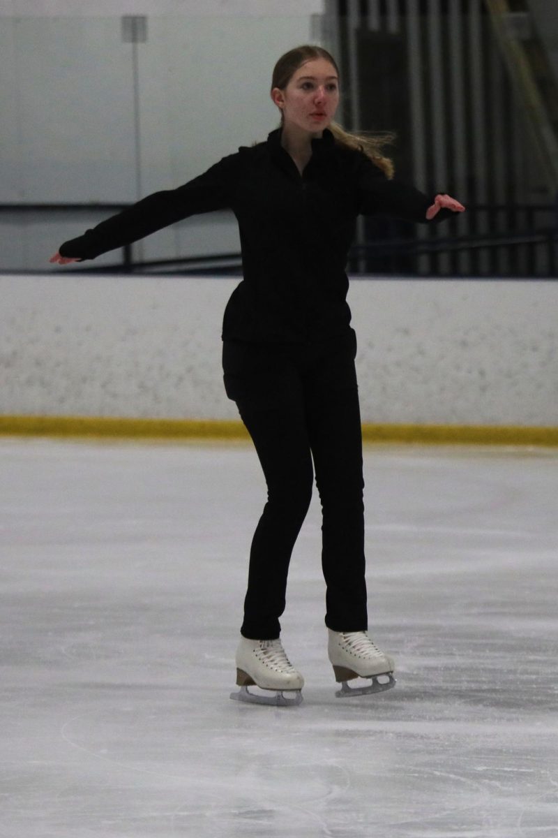 Freshman Delaney Konen reaches her arms out in front of her as she glides across the ice on Wednesday Feb. 5.  