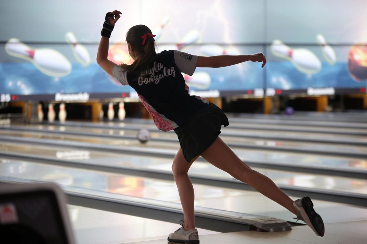 Posed, junior Layla Gonzalez watches as her ball rolls down the lane. 