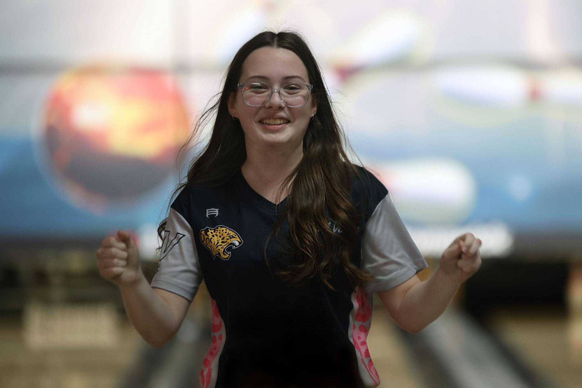 Cheering, sophomore Ella Diehl celebrates bowling three strikes in a row. 