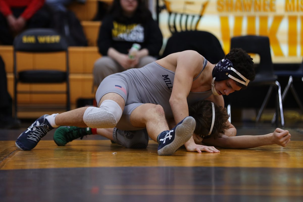 With the upper hand, sophomore Luke Whisler holds his opponent on the ground.