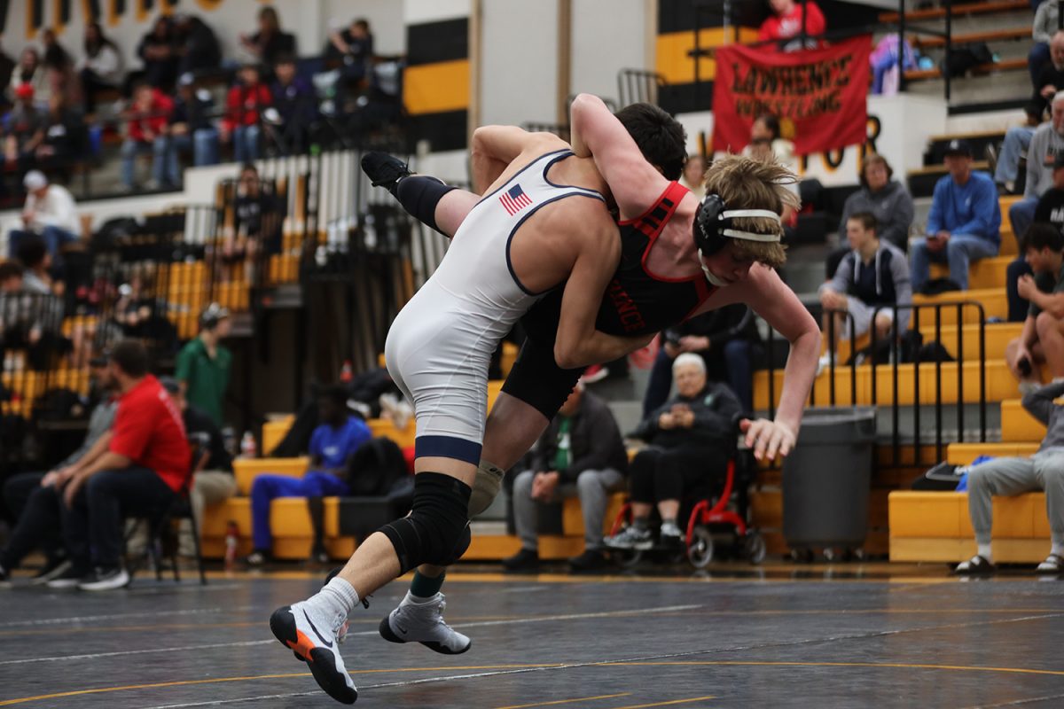 In the air, sophomore Ethan Leon slams his opponent onto the mat.