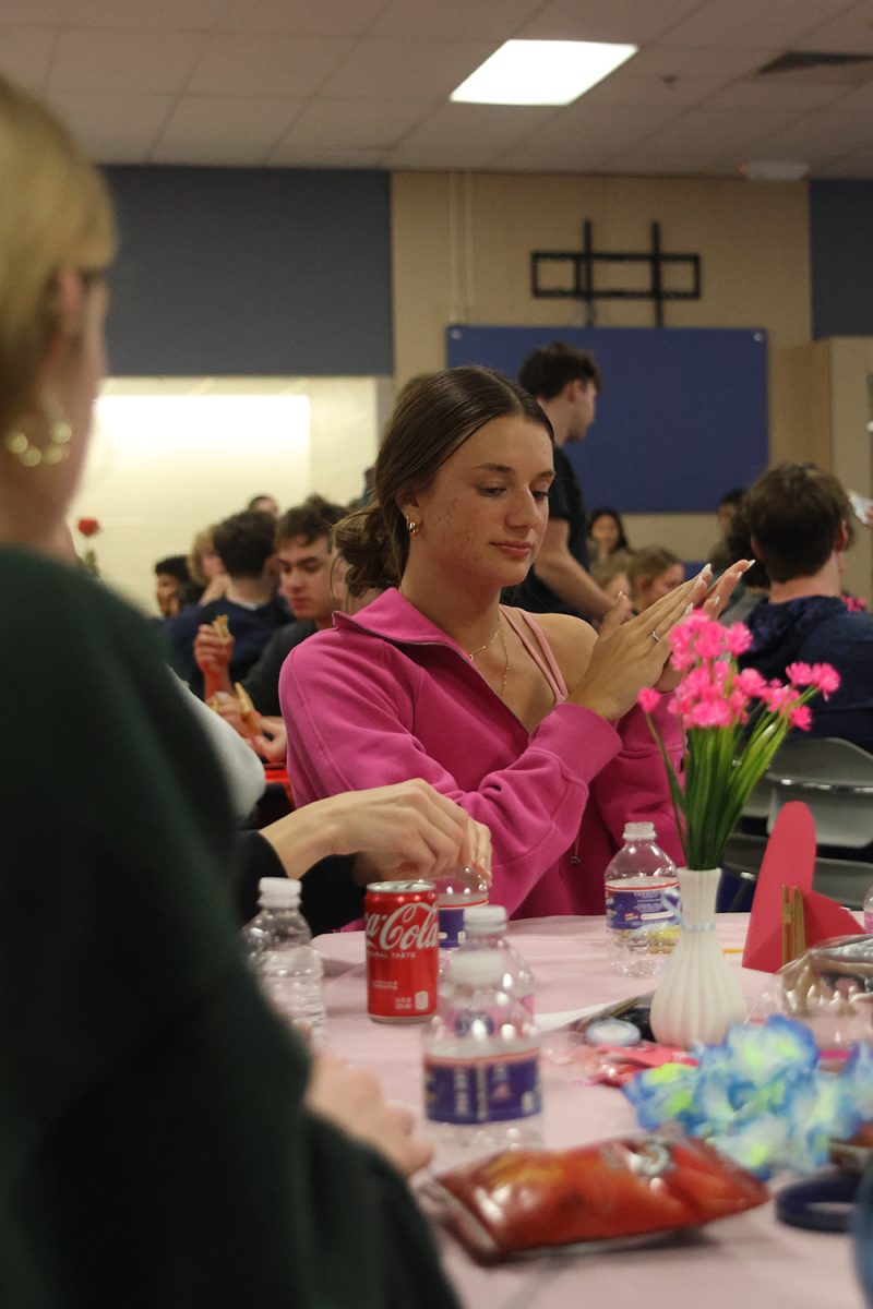 Hands together, senior Seville Skinner claps after her team gets the question right.