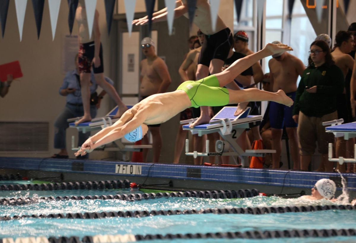 At his swim meet, sophomore Andrew Martin dives into the water. 